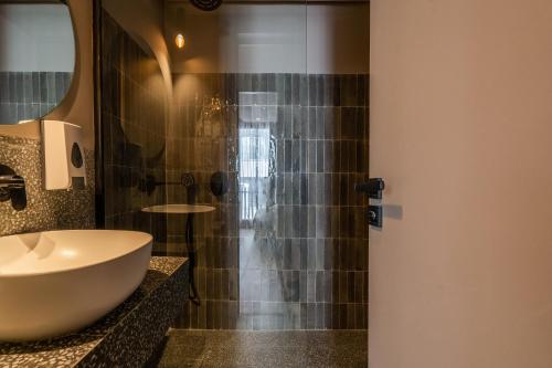 a bathroom with a sink and a shower at TWENTY SIX ANFA LUXURY RESIDENCE by Shortstaymaroc -Hyper Centre -Parking in Casablanca