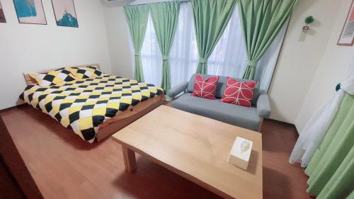 a living room with a couch and a bed at Happy house -405 in Takamatsu