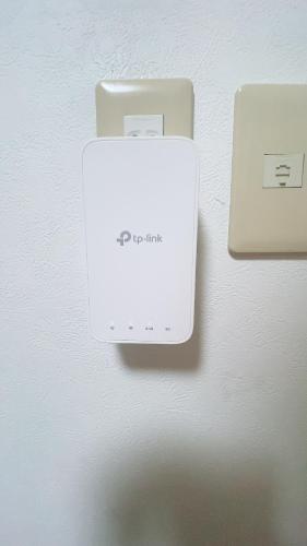 a white electrical box on a wall next to aswitch at Happy house -405 in Takamatsu