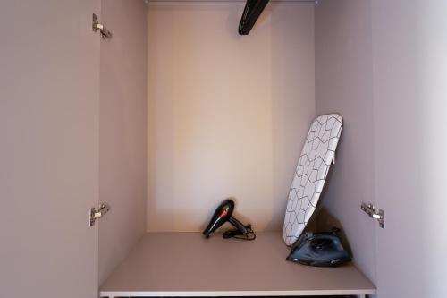 a shelf with a snowboard and a pair of scissors at TWENTY SIX ANFA LUXURY RESIDENCE by Shortstaymaroc -Hyper Centre -Parking in Casablanca