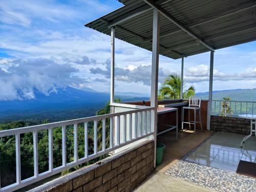 a balcony with a view of the mountains at Melbyls Hills Resort in Tomohon