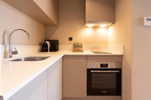 a small kitchen with a sink and a dishwasher at TWENTY SIX ANFA LUXURY RESIDENCE by Shortstaymaroc -Hyper Centre -Parking in Casablanca