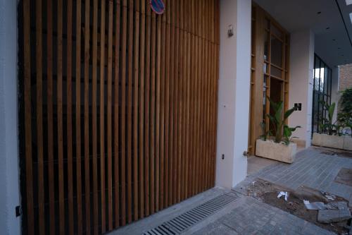 a wooden gate in the side of a building at TWENTY SIX ANFA LUXURY RESIDENCE by Shortstaymaroc -Hyper Centre -Parking in Casablanca
