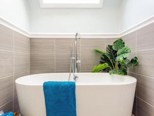 a bath tub in a bathroom with a blue towel at The Laurels in Rafford