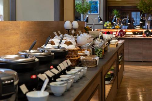a buffet line with dishes and utensils in a kitchen at Hotel Crescent Asahikawa in Asahikawa