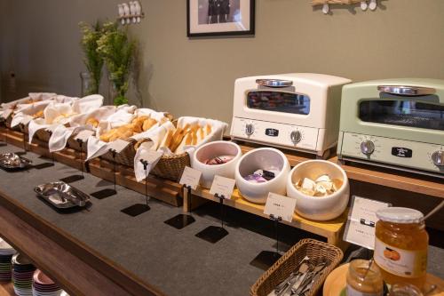 a display of bread and other food items on a counter at Hotel Crescent Asahikawa in Asahikawa