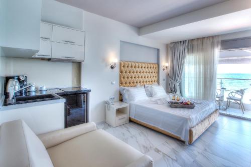 a hotel room with a bed and a kitchen at Art Boutique Suites in Pefkochori