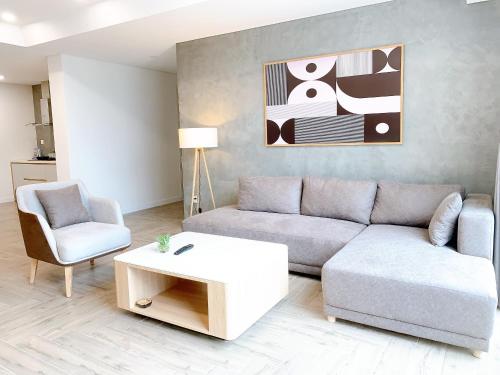 a living room with a couch and a coffee table at TSQ STAY Hotel Apartment in Hanoi