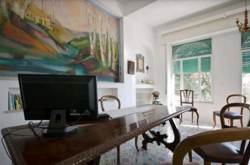 a living room with a desk with a computer on it at Villa Moschella in Taormina