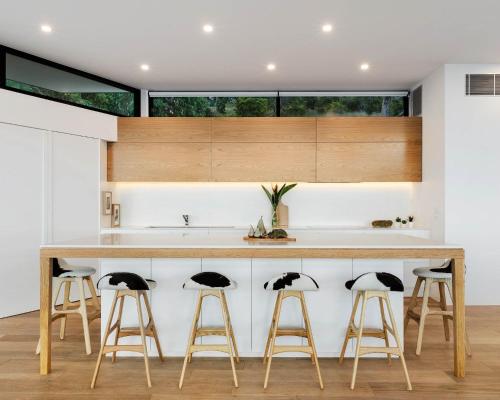 a kitchen with a large island with bar stools at Sea Ranch in Wye River