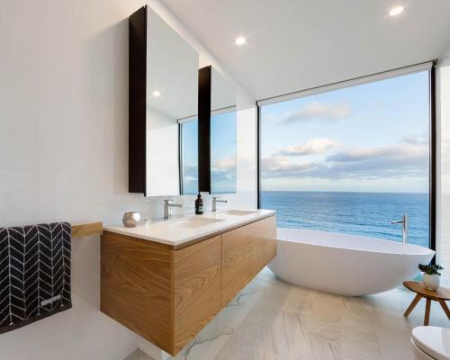 a bathroom with a tub and a large window at Sea Ranch in Wye River