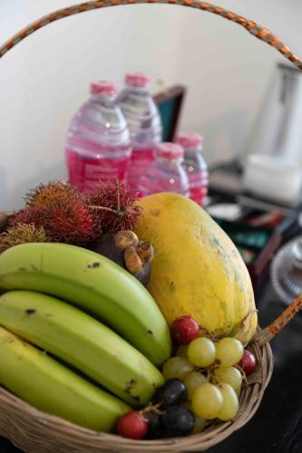 a basket filled with fruits and vegetables on a table at Lotus Colombo Guesthouse in Colombo