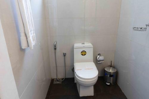 a small bathroom with a white toilet in a stall at Lotus Colombo Guesthouse in Colombo