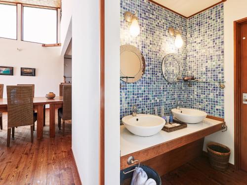 a bathroom with two sinks and a table at &SUN Penthouse in Yokosuka