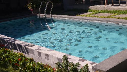 a swimming pool with a fountain in a yard at Samui Paradise Villa in Lipa Noi