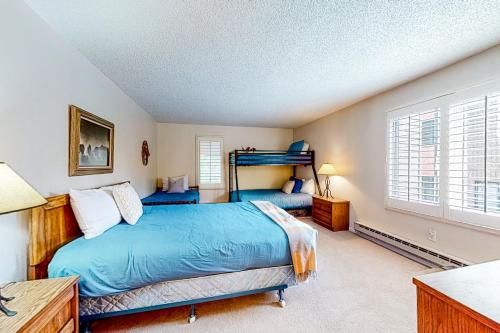 a bedroom with two beds and a window at Copper Grove in Copper Mountain