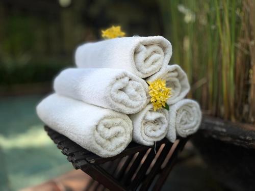 a pile of towels sitting on top of a bench at Villa Boreh Beach Resort and Spa in Tejakula