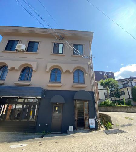 a blue and white building on a street at CABIN Nozawaonsen in Nozawa Onsen