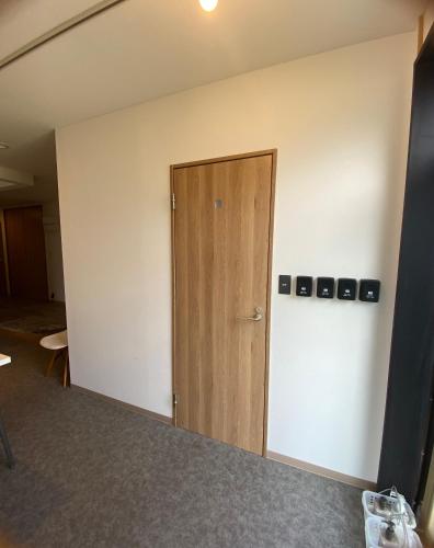 an empty room with a door in the wall at CABIN Nozawaonsen in Nozawa Onsen