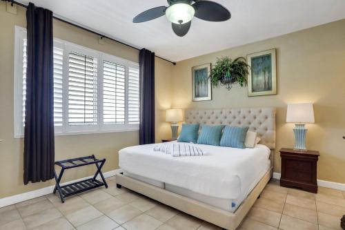 a bedroom with a bed and a ceiling fan at Shores of Panama 1912 in Panama City Beach