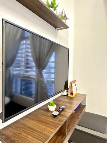 a large flat screen tv on a wall at Casa Ipoh Homestay by Comfort Home in Chemor