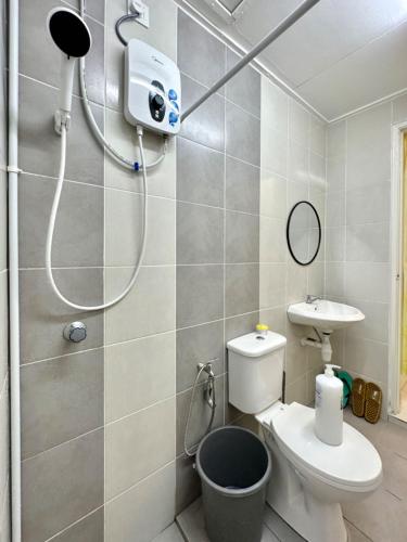 a bathroom with a shower and a toilet and a sink at Casa Ipoh Homestay by Comfort Home in Chemor