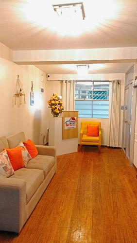 a living room with a couch and a yellow chair at MADA Guest House Puno "Hospedaje" in Puno