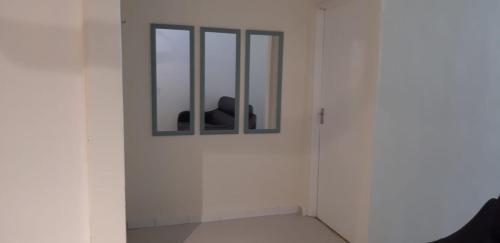 a person standing in a white room with a window at Ain's Homestay Muslim friendly Kuala Kubu Bharu in Kuala Kubu Baharu