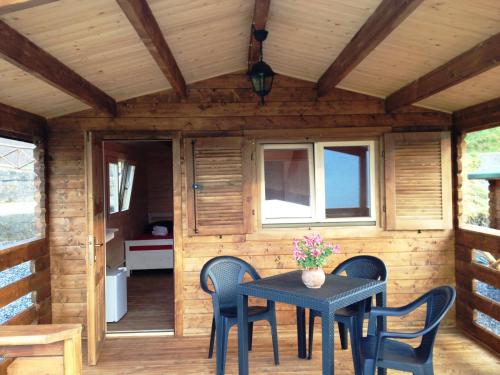 a tiny house with a table and chairs at B&B Lao in Papasidero
