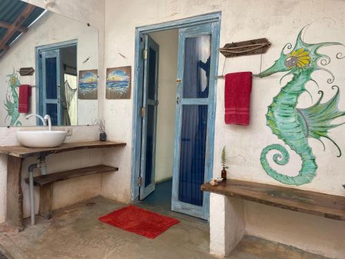 a bathroom with a seahorse painted on the wall at Blu oceano B&B, Italian restaurant in Nembrala
