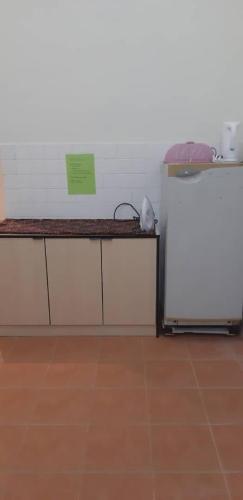 a room with a counter and a refrigerator at Ain's Homestay Muslim friendly Kuala Kubu Bharu in Kuala Kubu Baharu