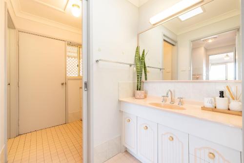 a bathroom with a sink and a mirror at 124 Rocky Point Rd - pet friendly, air con, Wi-Fi, high chair and Cot in Fingal Bay