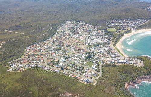 an aerial view of a city next to the beach at 124 Rocky Point Rd - pet friendly, air con, Wi-Fi, high chair and Cot in Fingal Bay