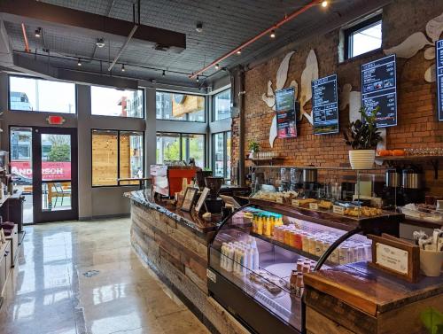 a restaurant with a bakery with a counter at The Vinyl Suite on Music Row in Nashville