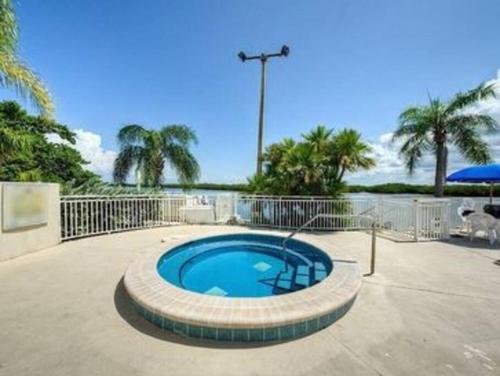 a small swimming pool in a patio with palm trees at Little Harbor Resort #109 Tampa Bay FL Beach, 2 Pools, Riverview in Ruskin
