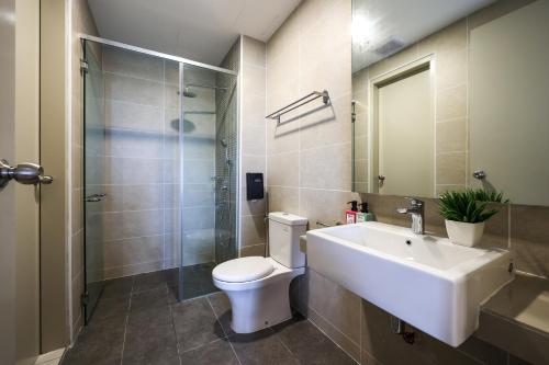 a bathroom with a sink and a toilet and a shower at Bali Residences @ Icon Stay Melaka in Melaka