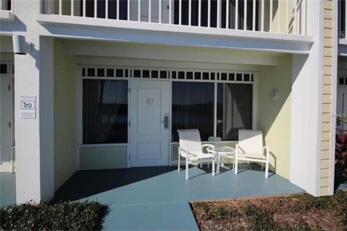 a patio with a table and chairs on a building at Little Harbor Resort #109 Tampa Bay FL Beach, 2 Pools, Riverview in Ruskin