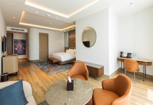 a hotel room with a bed and a table and chairs at Silk Road by Minyoun in Samarkand