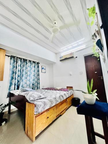a bedroom with a wooden bed in a room at Hammock Beach Home in Alleppey