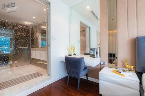 a bathroom with a sink and a glass shower at VINCOM Center Đồng Khởi District 1 in Ho Chi Minh City