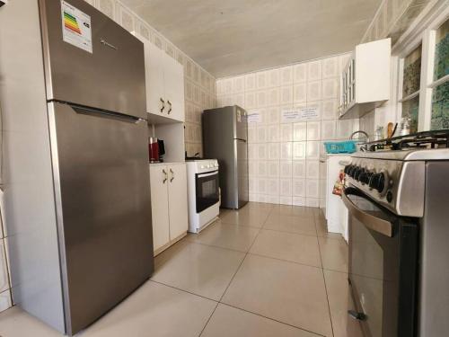 a kitchen with a stainless steel refrigerator and appliances at Arriendo Los Vilos, Central in Los Vilos