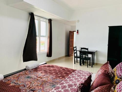 a bedroom with a bed and a window and a table at Coastal Bay Suite & Golf Cart Rental in San Pedro