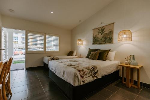 a bedroom with two beds and a window at Yeppoon Surfside Motel in Yeppoon