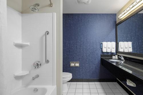 a bathroom with a toilet and a blue wall at Fairfield Inn & Suites by Marriott Paducah in Paducah