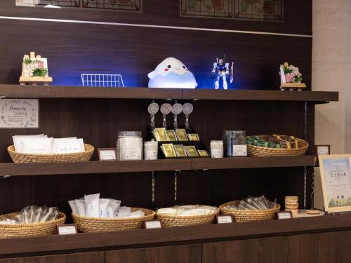a shelf with wicker baskets and other items on it at Hotel Wing International Shizuoka in Shizuoka