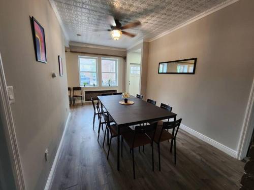 a dining room with a table with chairs and a ceiling fan at Vast Stylish Apt Close to NYC! in North Bergen