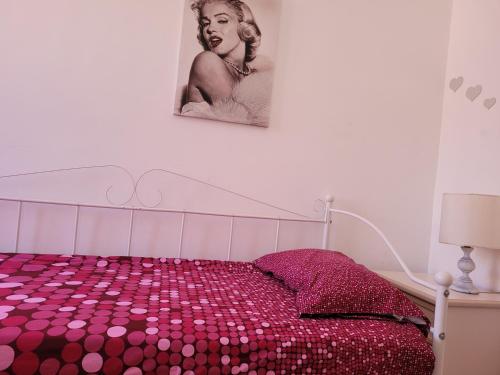 a bedroom with a bed with pink polka dots at ROME SWEET ROME - close to line A San Giovanni in Rome