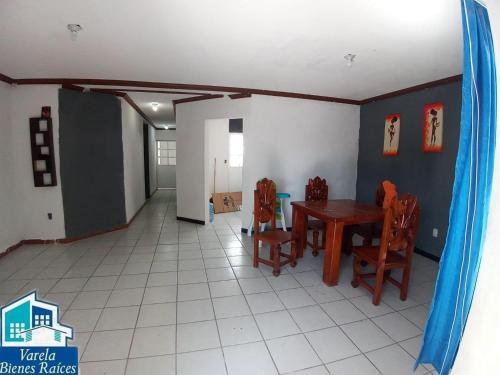 a dining room with a table and chairs at Black House in Silao