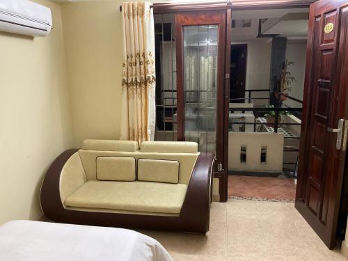 a bedroom with a chair and a bed and a window at Khách sạn Minh Châu - Hòa Hưng in Ho Chi Minh City