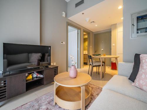 una sala de estar con un sofá y una mesa en Business Bay's Coziest Hideaway With Balcony, en Dubái